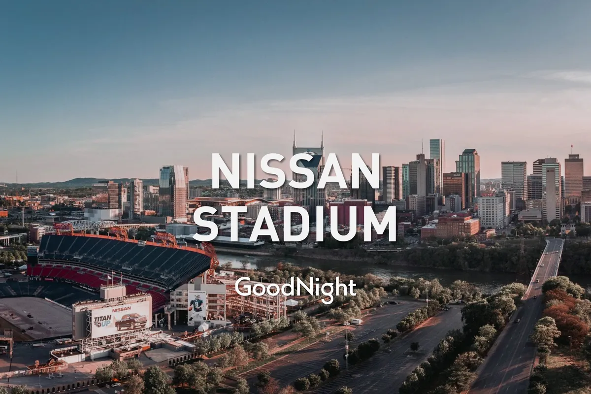 The image showcases Nissan Stadium along the river, with the Nashville city skyline in the background. The tranquil setting hints at both the energy of sporting events and the accessibility of downtown attractions, connecting guests to the broader excitement of Nashville.